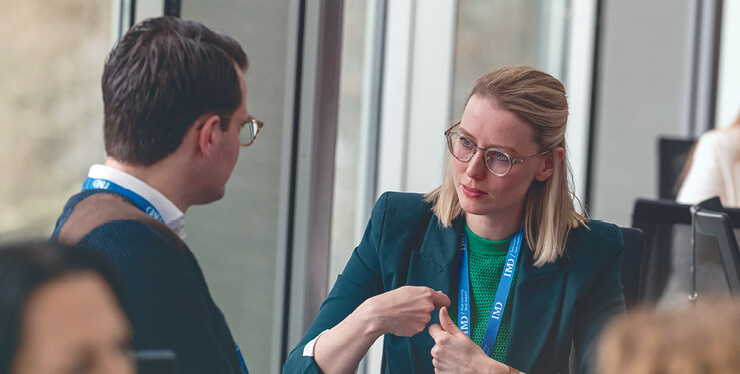 a man and a woman having a debrief following a talent assessment - IMD Business School